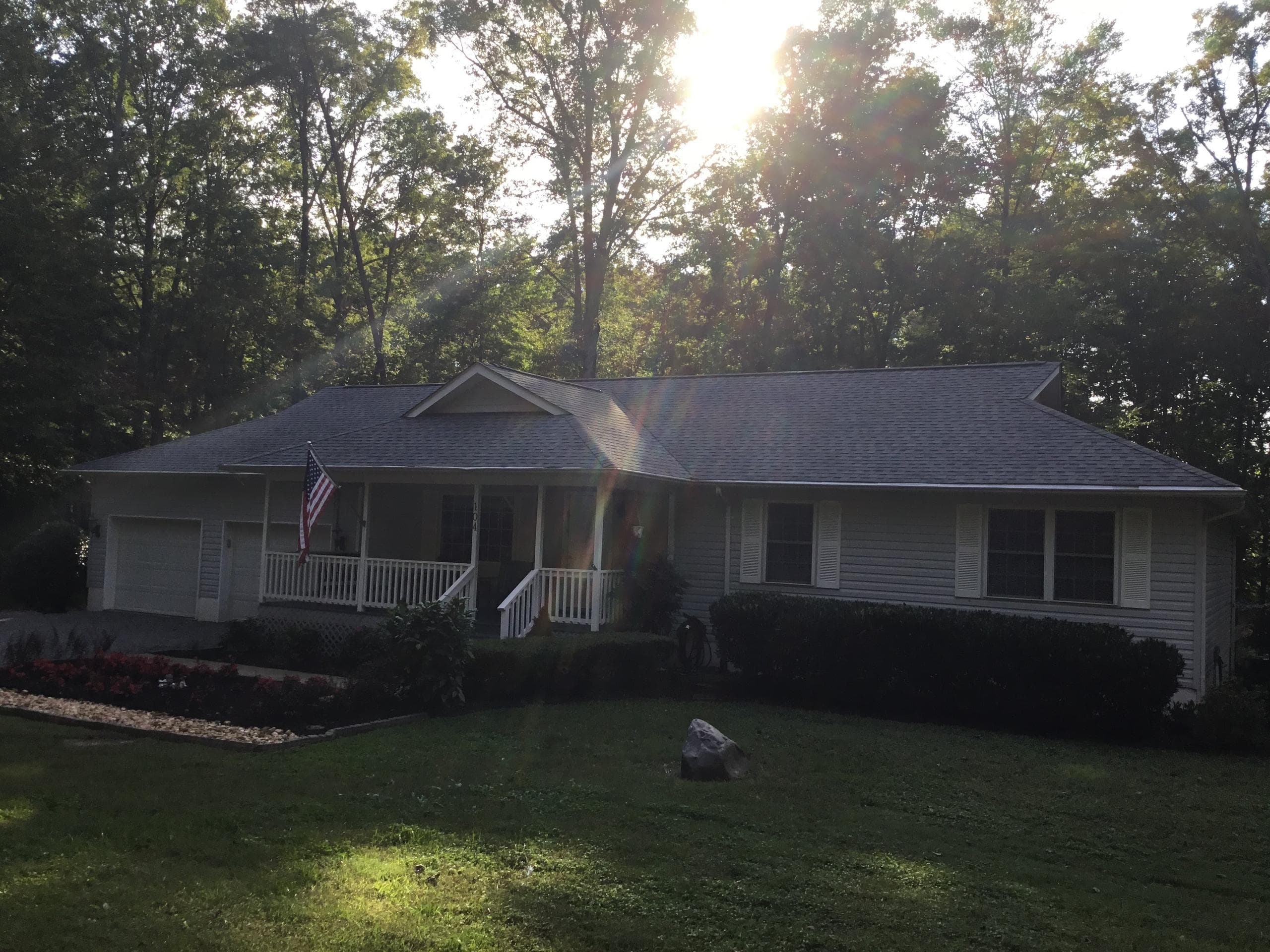 Beautiful two story home with trimmed bushes and a cut lawn