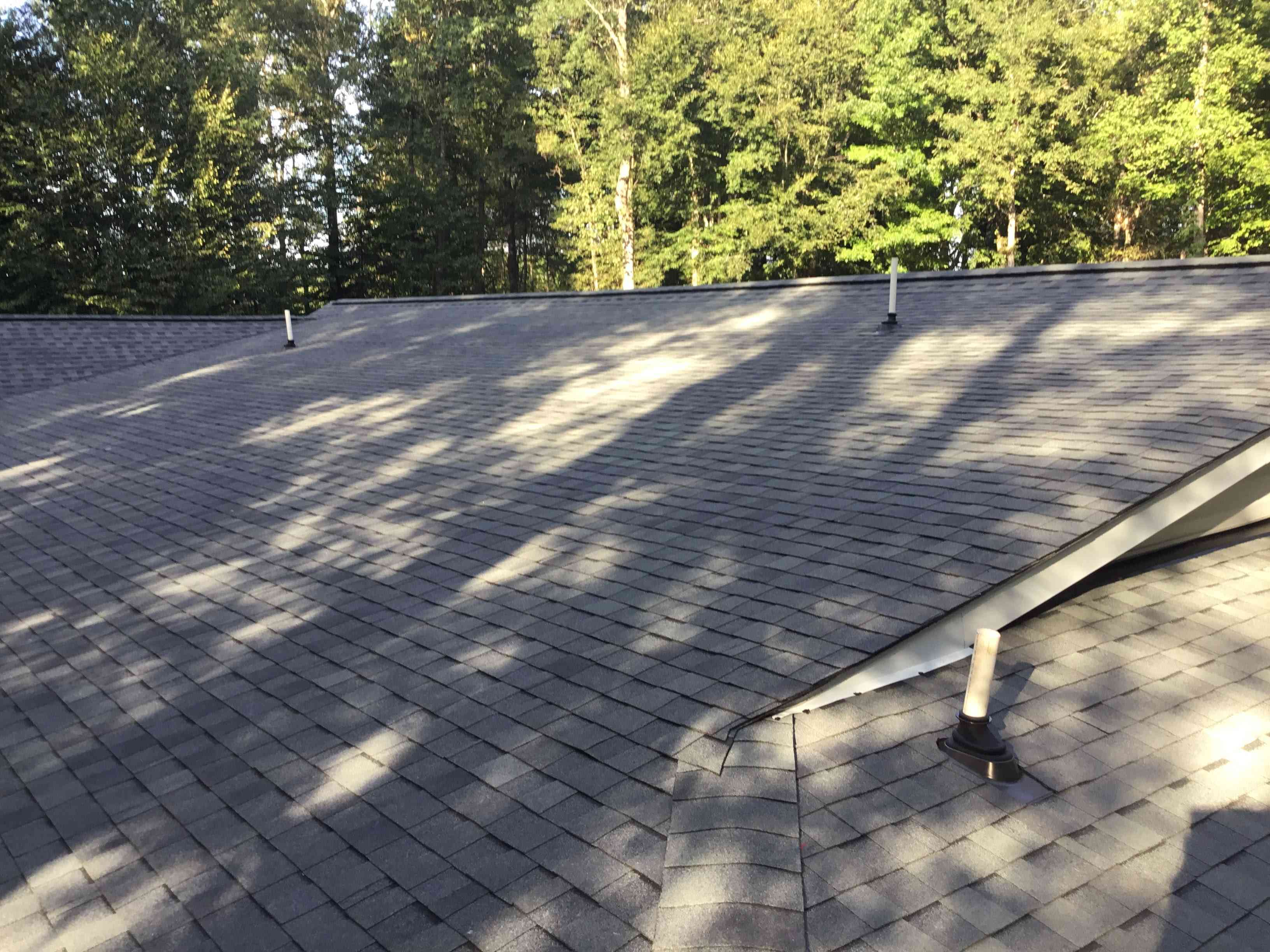 Two story house with a garage and a new black roof